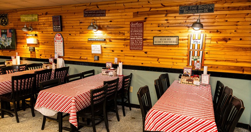 Dining area with tables and chairs, and red and white tablecloths