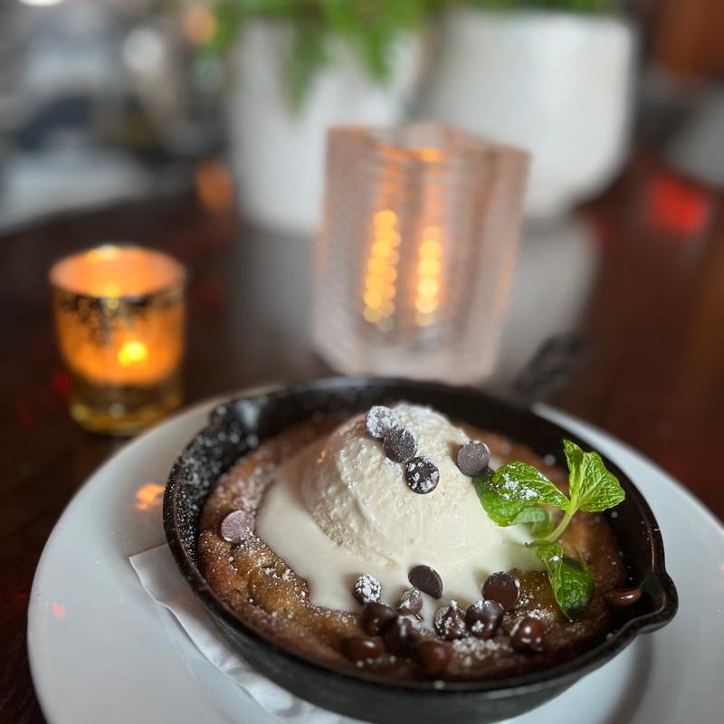 Chocolate Chip Cookie with a Scoop of Vanilla. Enough for 2 or just for you. (No, you should not touch the cast iron pan to test!) photo