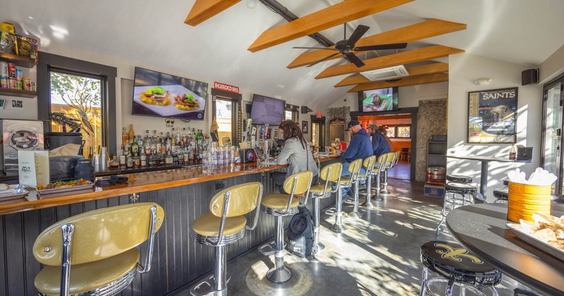 Interior, bar and bar stools, guests sitting