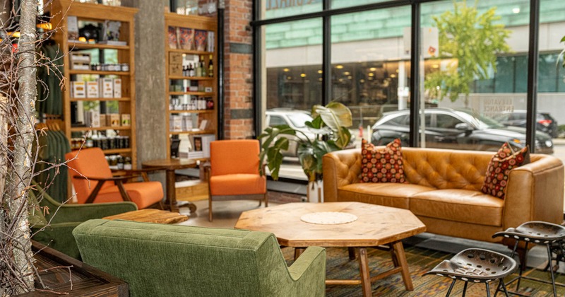 Interior, lounge area, sofas with padded armchairs and coffee tables, carpet flooring