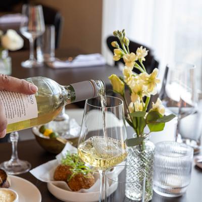 Pouring a glass of white wine.