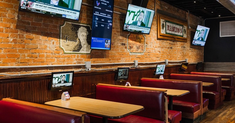 Interior, booth area, leather seats, TVs on the wall