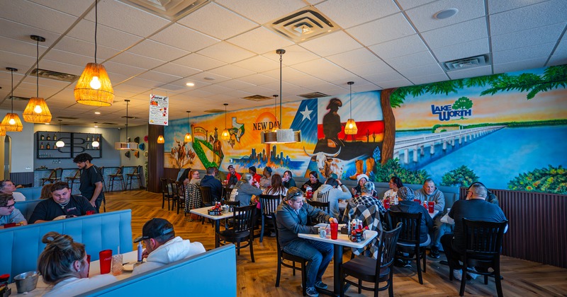 Cozy interior dining area full of guests enjoying their food and drinks