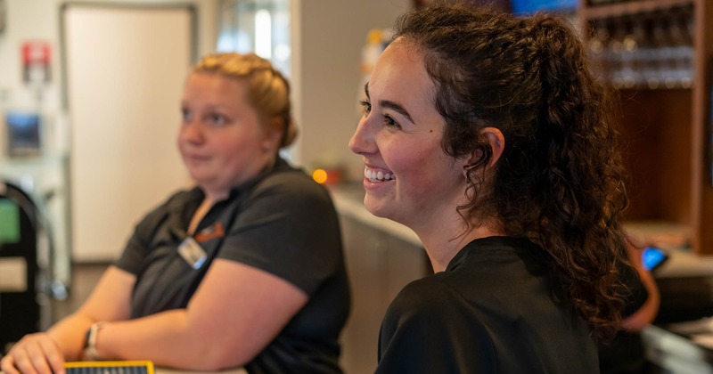 Interior, two staffers at the bar