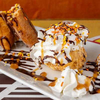 Fried ice cream with sprinkles and chocolate syrup.