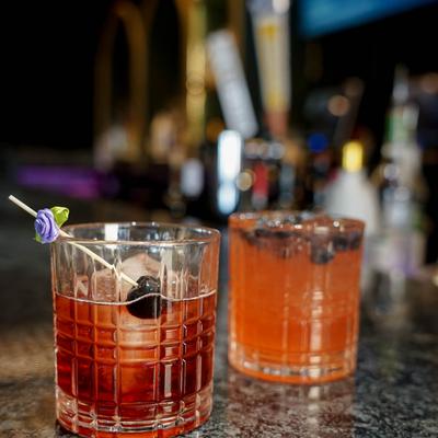 PB&J Old Fashion and an orange cocktail with blueberries