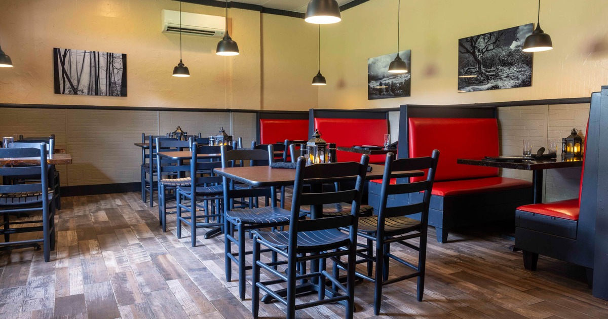 Dining area, tables ready for customers, pictures on the walls as a decoration