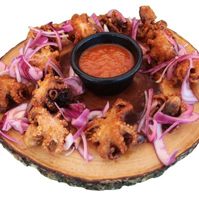 Deep-fried octopus served with fresh red onion and a cup of salsa.