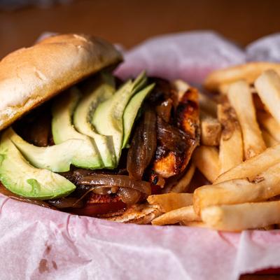 Grilled Cajun Chicken Avocado with a side of fries.