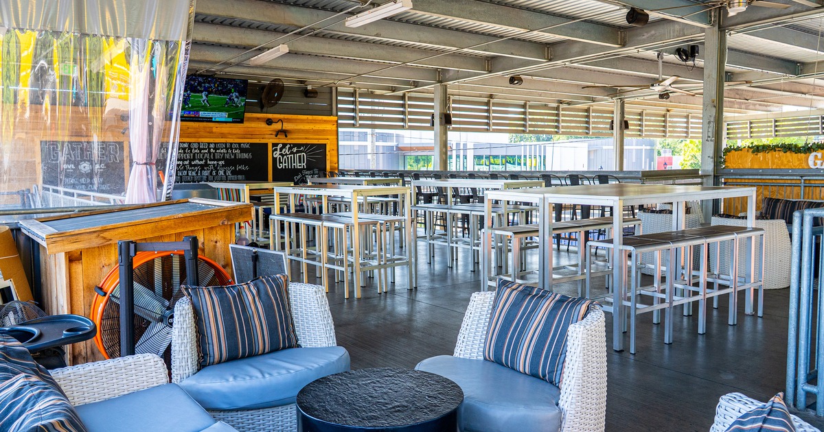 The outdoor seating area, high-top tables and comfortable lounge chairs