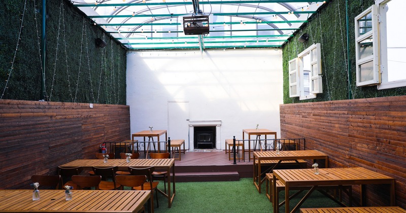 Covered backyard, tables and chairs, candle lights, romantic atmosphere