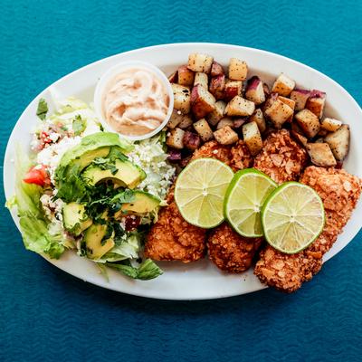 Nuggets, baked potato, salad and lemon on the side