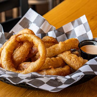 Fried onion rings with a sauce for dipping.