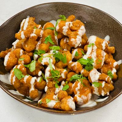 Fried and breaded cauliflower, smothered in buffalo sauce.