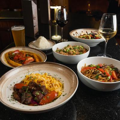 Plated dishes and drinks on a restaurant table.
