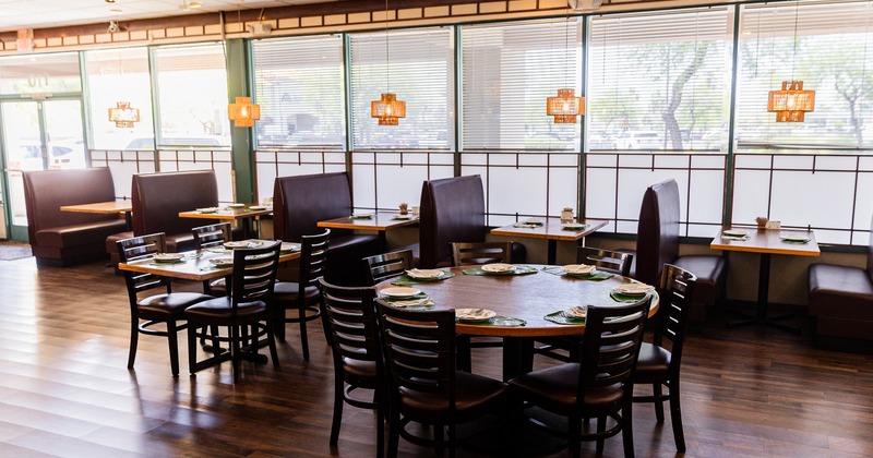Cozy and spacious interior dining area with dining tables set for guests