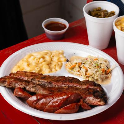 Two meat plate with sausage, brisket, mac and cheese, and coleslaw.