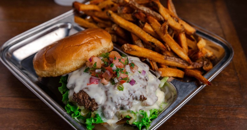 Cheeseburger topped with fresh salsa and lettuce, served with fries