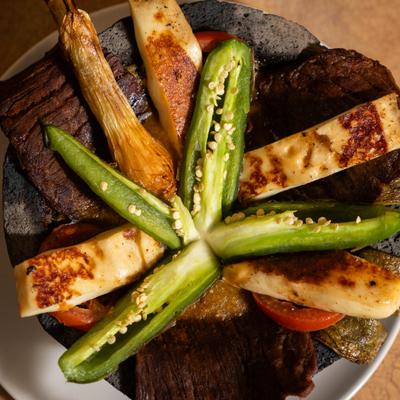Molcajete Azteca with grilled meat, cheese and jalapenos.