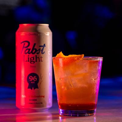 Cocktail and a can of beer.