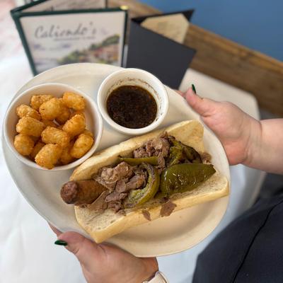 Hands holding a meal on a platter.