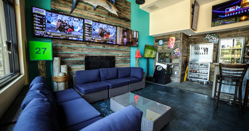 Lounge area, large TV screens in the wall