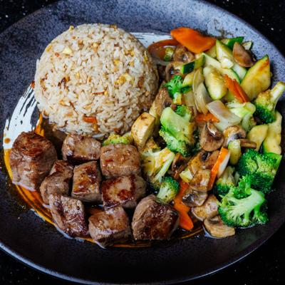Hibachi steak served with fried rice and vegetables.