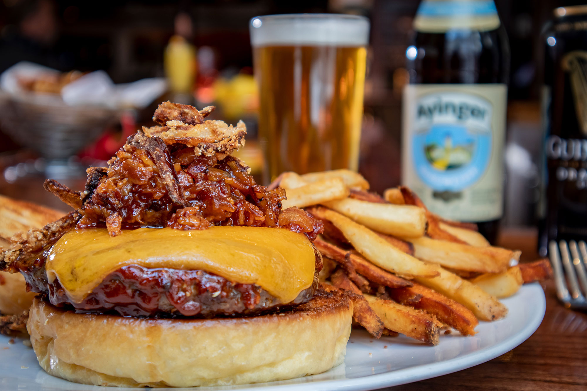 Grilled meat with melted cheese, fries on the side