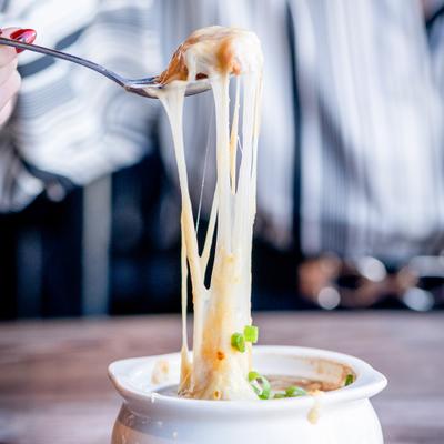 Cheese from the French onion soup stretching.