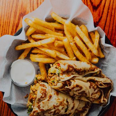 Crispy chicken wrap with fries and dipping sauce.