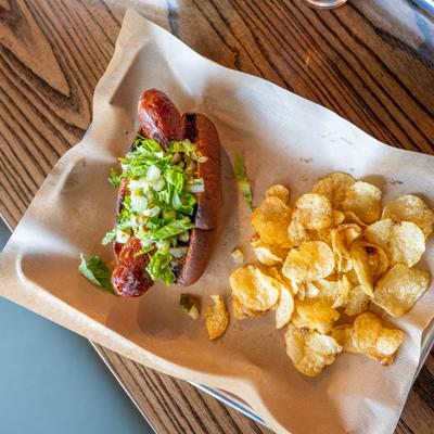 Ragin Cajun Dog served with chips.