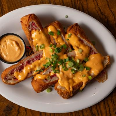 Reuben eggrolls served with thousand island dressing.