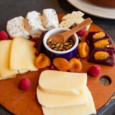 cheese plate with sulguni cheese, guda cheese, candied nuts, dried fruits and raspberries