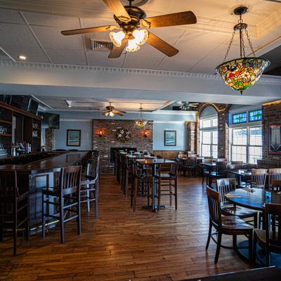 Interior, wide view of the room featuring a bar and seating area.