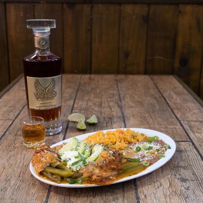 Chile Relleno dish, and a bottle of tequila on the side
