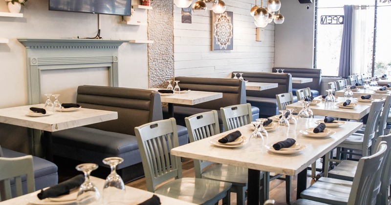 Booths and tables with tableware ready for guests