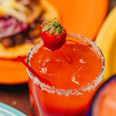 Strawberry margarita with salted rim and strawberry garnish.