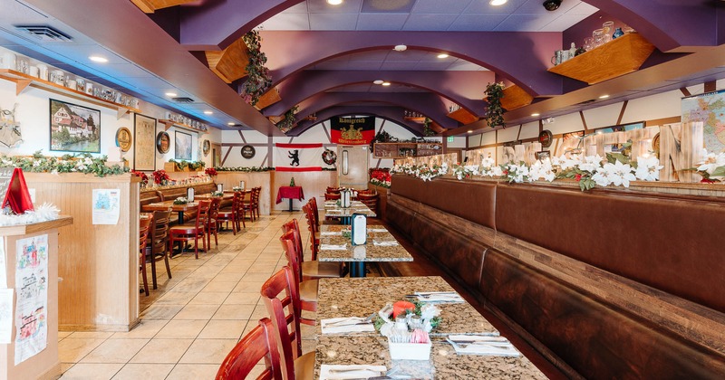 Interior, tables and chairs lined up with tableware