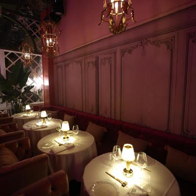 View at the booths with set tables amd armchairs.