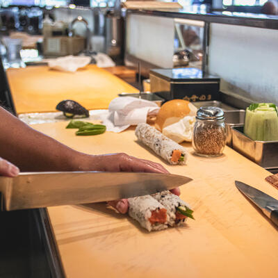 Staff member making sushi in the kitchen