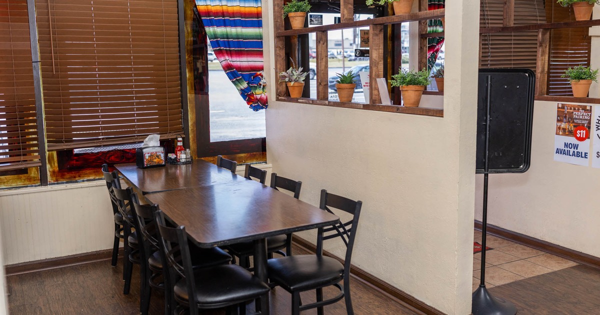 Interior seating area with chairs and tables, floral decoration