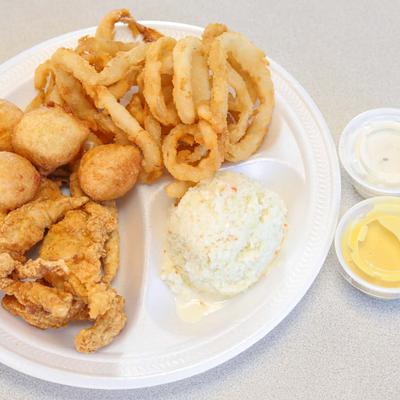 Chicken tenders, with onion rings and hush puppies, salad and sauce dips
