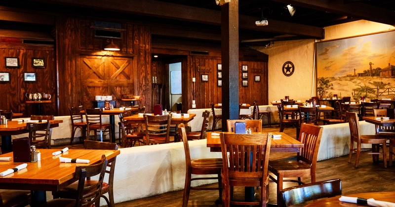 Cozy, rustic-style interior dining area with set tables