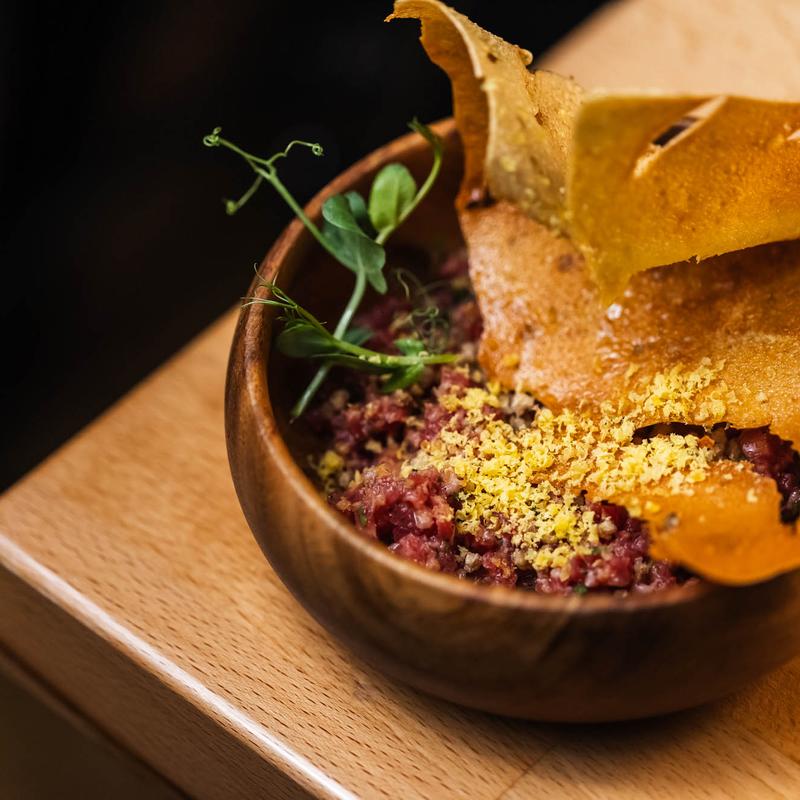menu item 8 of 22, Grass Fed Steak Tartare, Fermented Pepper, Sesame, Buckwheat, Celery Root, Cured Egg Yolk*