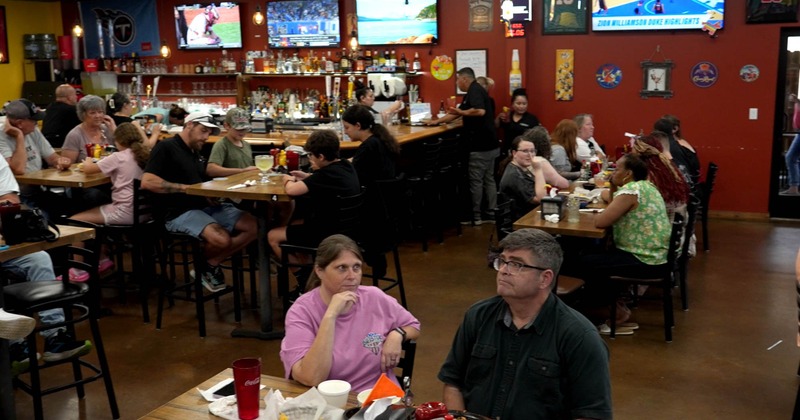 Diner tables, chairs, guests