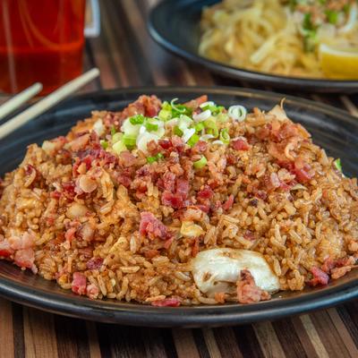 Bacon fried rice topped with scallions.