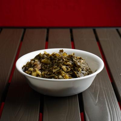 Bowl of Collard Greens served on the table.