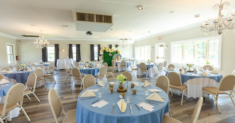 Banquet room with set tables and seating ready to receive guests
