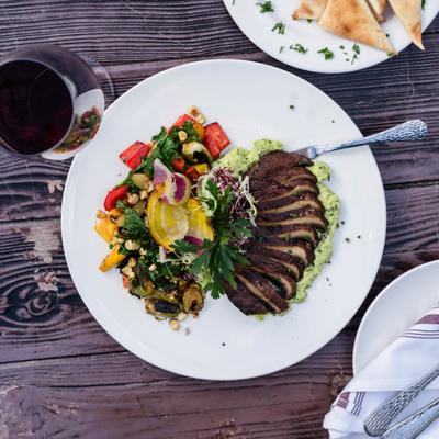 Edamame Hummus with Roasted Portobello Mushroom served with a glass of wine.