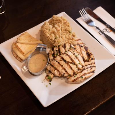 Grilled chicken breast, served with rice, pita and sauce.